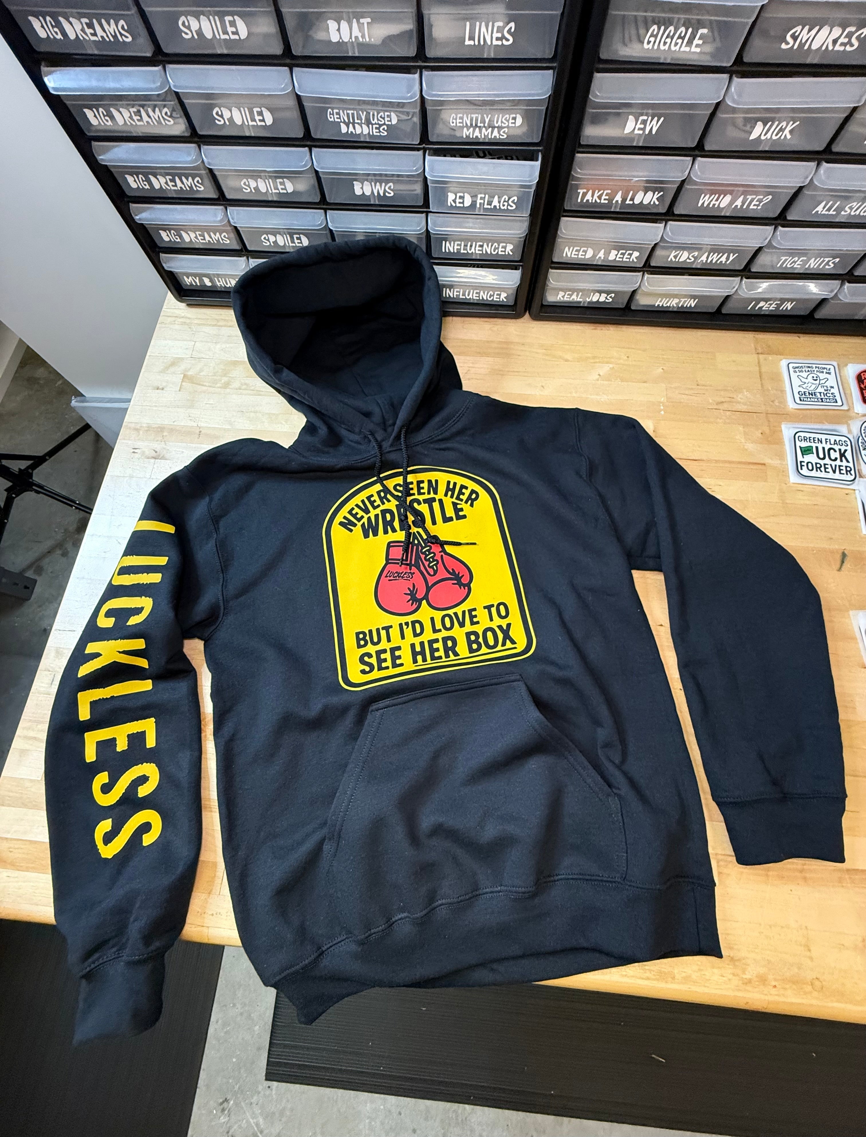 Never Seen Her Wrestle But I'd Love to See Her Box | Funny Men's Premium Black Graphic Hoodie